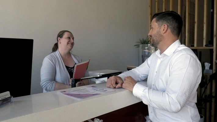 Chiropractor Calgary AB DJ LeDrew Talking With Admin Staff Chiropractor Calgary AB DJ LeDrew Talking With Admin Staff