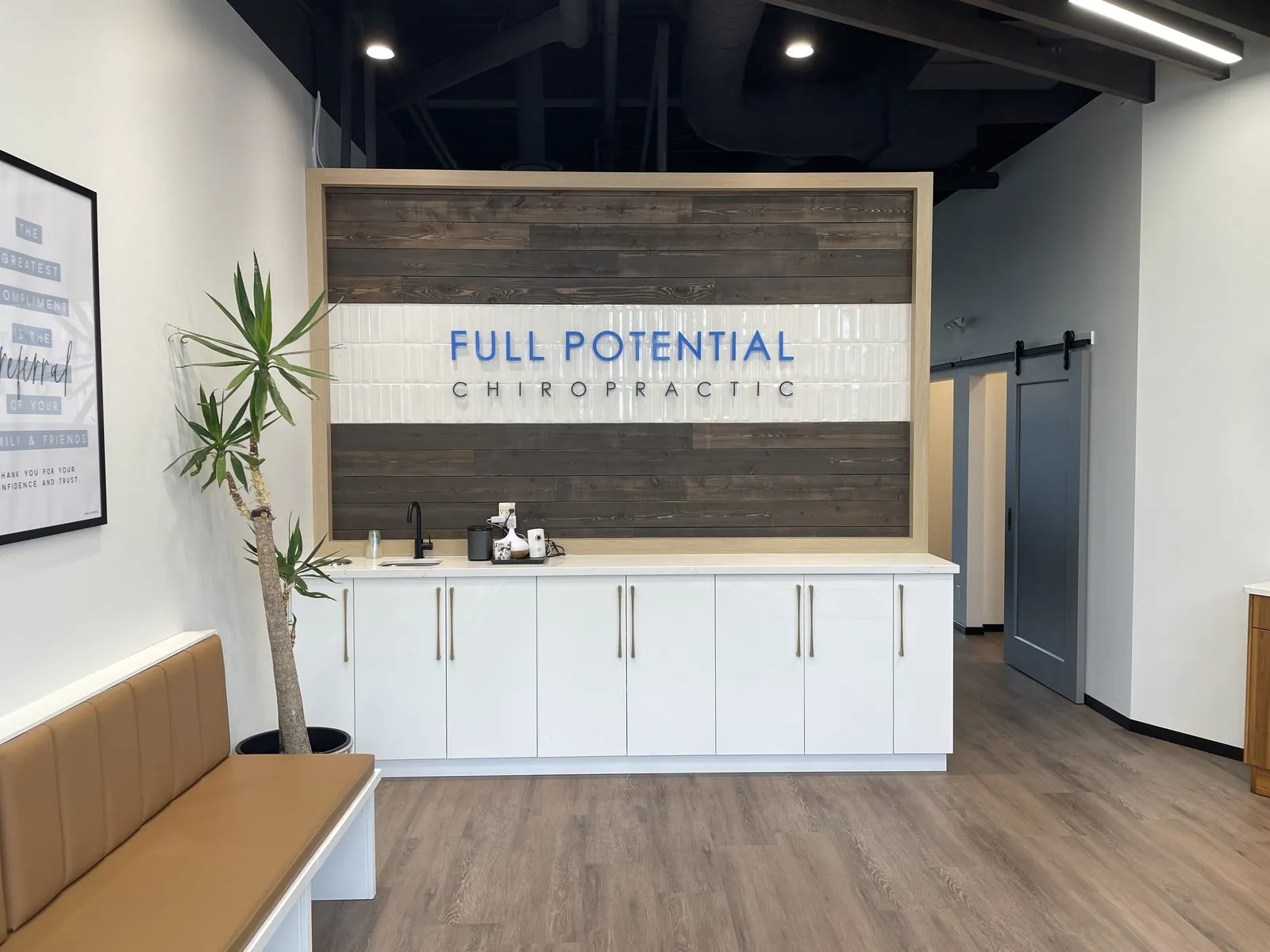 fp-reception-signage Chiropractic treatment bays at Full Potential Chiropractic, Calgary SW.